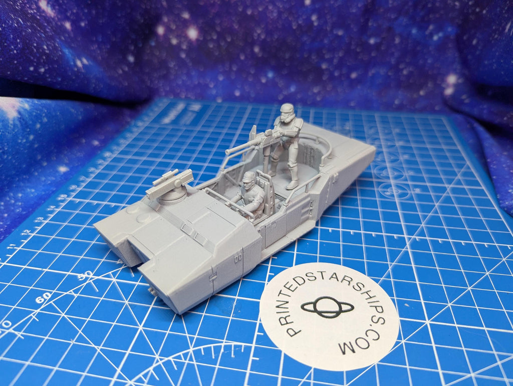 May include: A gray 3D printed model of a Star Wars speeder with two figures in the cockpit. The speeder has a raised gun turret on the front and a printed logo on the side that reads 'PRINTEDSTARSHIPS.COM'.